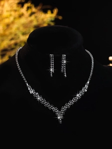 Exquisite V-shaped zircon necklace and tassel earrings set on black display stand