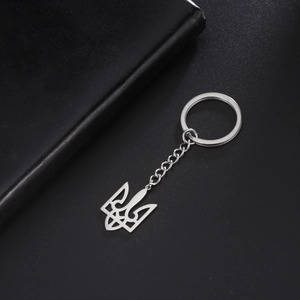 Detailed close-up of a silver stainless steel keychain with a Ukraine emblem pendant