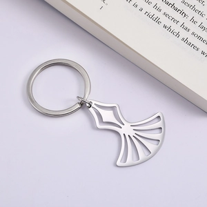 Macro shot of polished stainless steel cutout fan pendant on a silver keychain ring