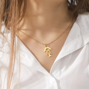 Elegant gold hollow girl pendant necklace in stainless steel worn on a white shirt