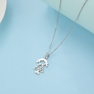 Close-up of cut-out girl pendant in stainless steel with a delicate silver chain