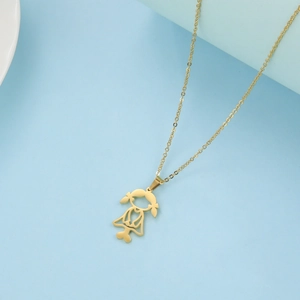 Detailed macro view of a gold-plated stainless steel necklace with a hollow girl pendant