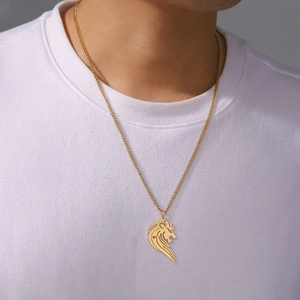 Goldene Edelstahlkette mit hohlgeformtem Löwenkopf-Anhänger getragen auf weißem T-Shirt
