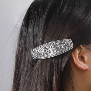 Detailed view of a vintage silver hair clip with Tree of Life and Celtic knot patterns