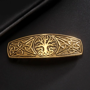 Close-up of vintage gold hair clip featuring Celtic knot and Tree of Life design