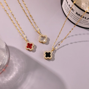 Three elegant four-leaf clover necklaces with red, black and white crystals in gold finish