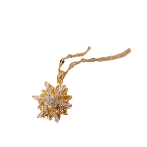 Elegant rotating flower pendant necklace with micro-paved zircons and gold steel finish