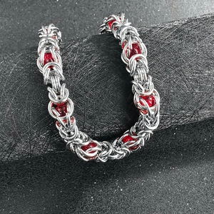 Men's titanium steel Byzantine chain bracelet with red beads on a black cylinder