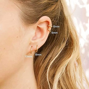 Three gold stainless steel hoop earrings in 6mm, 8mm, and 10mm sizes worn on the ear