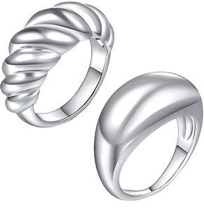 Makroaufnahme von gedrehtem Seil und glatten, gewölbten Ringdesigns aus Edelstahl