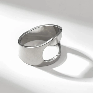 Modern minimalist wide band ring in polished stainless steel with circular cutout