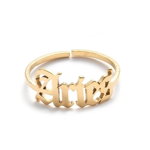 Detailed macro view of the gold Aries zodiac letter engraving on a minimalist open ring