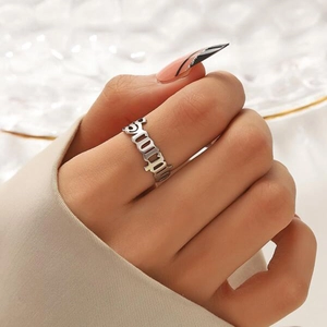 Macro detail of silver stainless steel ring with hollow DADDY gothic letter design