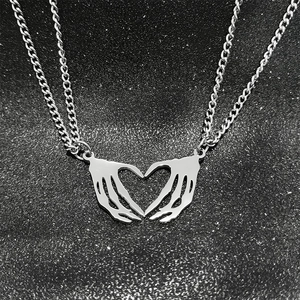 Gothic punk style skeleton hands forming a heart pendant on stainless steel chain necklace
