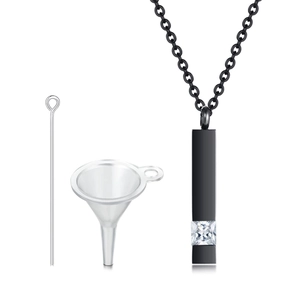 Detail of black cylinder urn necklace with clear stone including filling funnel and pin tool