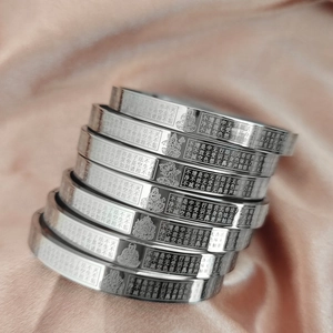Polished stainless steel Buddhist Heart Sutra bangles featuring engraved Buddha motifs