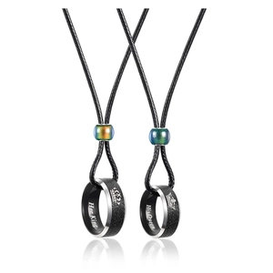 Detail of Her King and His Queen engraved rings on cord with color-changing beads