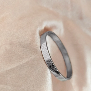 Macro view of Chinese Zodiac Heart Sutra bracelet with laser engraved script and patterns