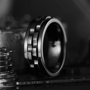 Macro shot of rotatable titanium steel ring featuring gear patterns and mechanical textures