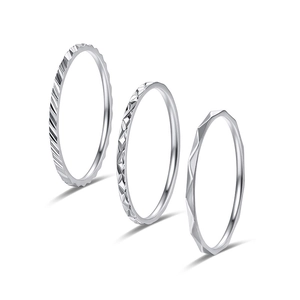 Three-piece set of thin titanium steel rings with textured geometric patterns in silver finish