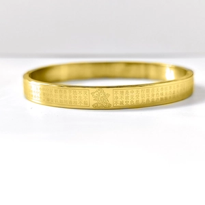 Golden stainless steel Heart Sutra bangle featuring Buddha engraving and Buddhist scriptures