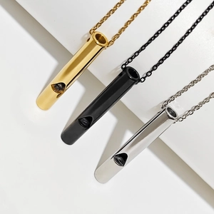 Polished stainless steel whistle necklaces in gold, black and silver finishes on white