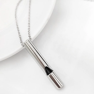 Close-up of a silver stainless steel cylindrical whistle pendant necklace with an O-chain