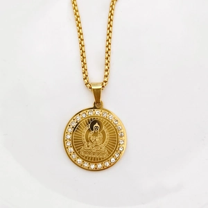 Macro detail of golden circular Buddha pendant with sparkling crystals on box chain