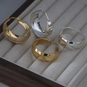 Polished chunky hoop earrings set in 18K gold and silver finish for women