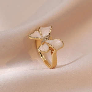 Elegant gold-tone adjustable bowknot ring with creamy white enamel and zirconia