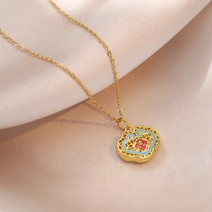 Golden Ruyi lock necklace with red enamel and auspicious character on pink silk background