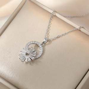 Elegant sunburst zircon pendant necklace with silver chain displayed in a gift box
