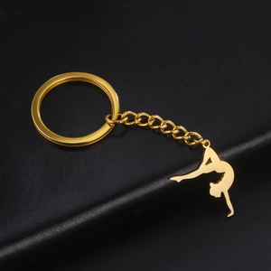 Macro shot of a golden gymnast silhouette charm on a stainless steel keychain link