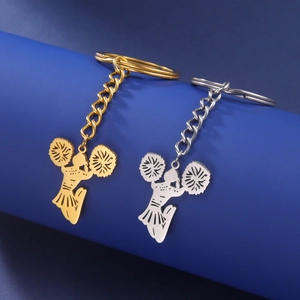Macro detail of cheerleader silhouettes on gold and silver stainless steel keychains