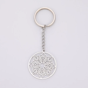 Detailed view of silver stainless steel keychain with hollow geometric mandala pattern