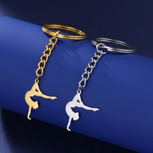 Polished gymnast silhouette keychain charms in gold and silver finish on display