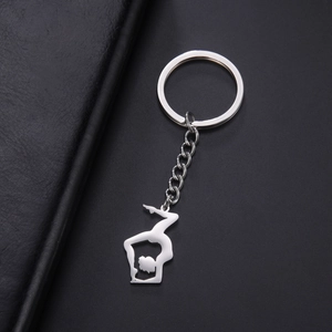 Polished stainless steel keychain with gymnastic yoga silhouette on black leather