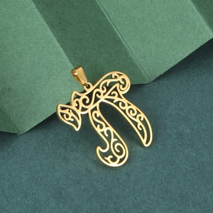 Detailed view of hollow gold stainless steel pendant with intricate wave engraving