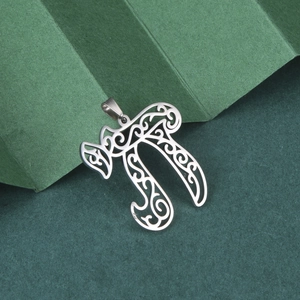 Detailed macro view of silver Chai symbol pendant in hollowed stainless steel
