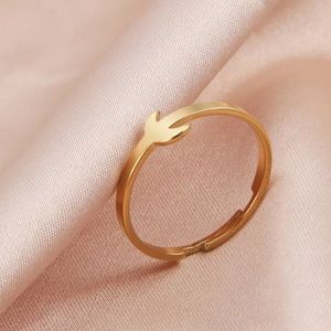 Elegant gold crescent leaf open ring on pink silk background for a minimalist style