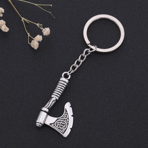 Detail of vintage silver axe pendant featuring intricate Celtic knot patterns and textures