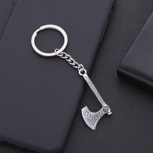 Detailed close-up of silver zinc alloy axe keychain with Viking Celtic woven patterns