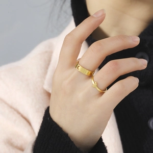 Gold stainless steel ring set with crescent moon cutout and small animal charm details