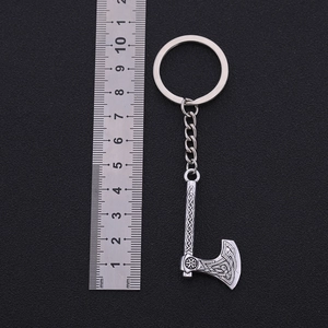 Vintage silver zinc alloy axe keychain with Nordic carvings and ruler for size scale