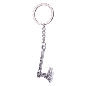 Viking style silver axe keychain with Celtic knot engravings on a clean white background