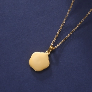 Macro view of a gold 304 stainless steel necklace with a smooth flower pendant