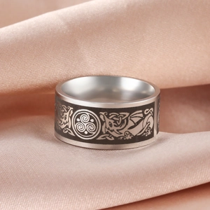 Vintage stainless steel ring with black Celtic triskele and dragon engravings on silk