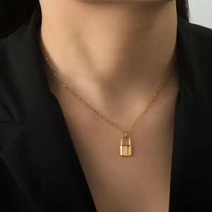 Elegant 18K gold-plated stainless steel padlock necklace displayed on a fashion model