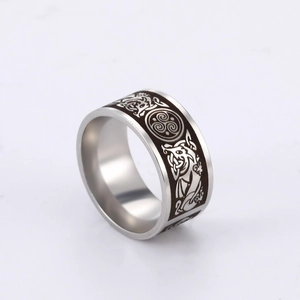 Macro view of wide stainless steel ring featuring laser etched Celtic triskelion totem