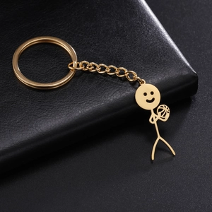 Polished gold stickman pendant holding a ball with smiley face on black leather